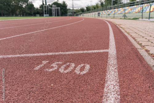 Ground-level shot of an athletics track at its 1,500-meter distance mark.