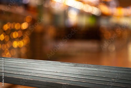 empty wooden brown table on blurred light gold bokeh cafe restaurant bar, place for your products on the table. Abstract background © Egor