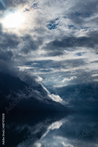 Clouds rolling in above fhord in Norway during summer