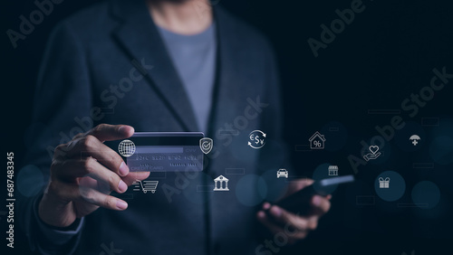 Man using smartphone and credit card pay via mobile banking app for online payment with digital money technology icons. Online shopping, Financial transaction, Digital bank, Internet payment concept. photo