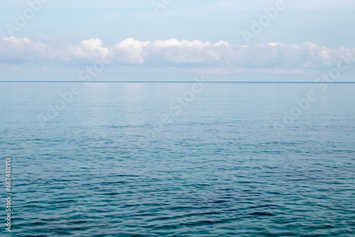 Blue ocean panorama, expansive scene with clear sky, ripple wave and calm sea with beautiful sunshine © Oksana