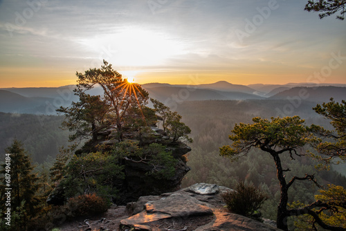 Landscape shot in sunrise, cold winter landscape from a sandstone rock in the middle of the forest. Pure nature in the morning from a viewpoint, the Schlüsselfelsen in the Palatinate Forest, Germany photo
