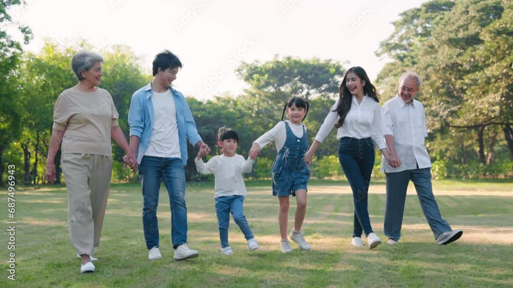 Happy Asian family walking and talking together in the garden, Outdoor in the park with big family concept Happy Asian family walking and talking together in the garden, Outdoor in the park with big family concept