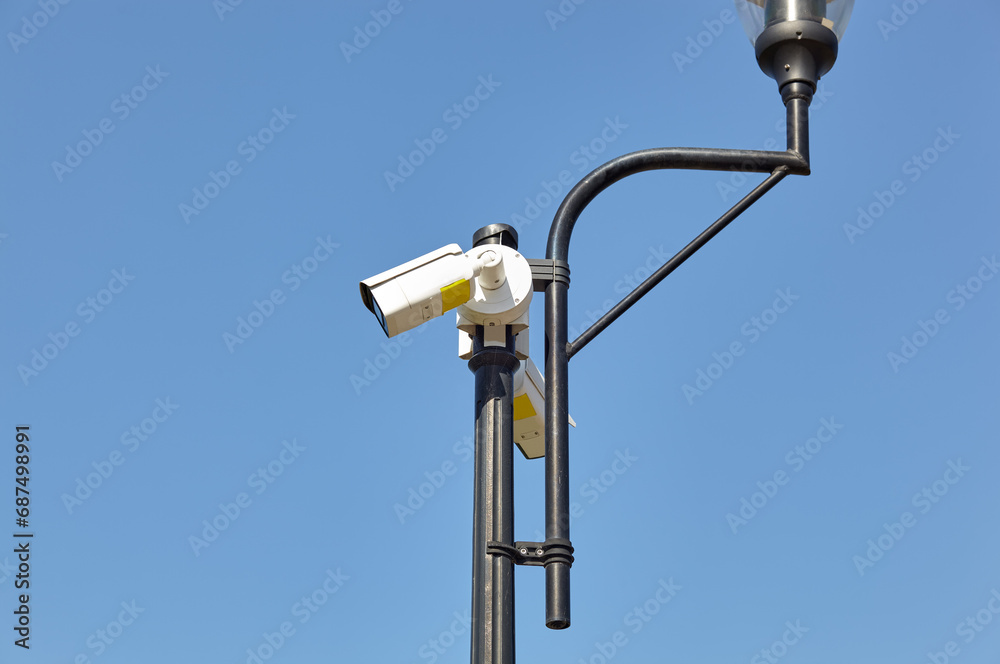 Cctv camera security on pole. Modern surveillance CCTV camera on lamppost on a city street Cctv camera security on pole. Modern surveillance CCTV camera on lamppost on a city street