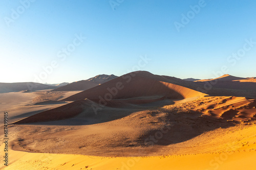 Fototapeta Naklejka Na Ścianę i Meble -  Exterior shot of the Namibian Sossusvlei sanddunes near the famous Dune 45 around sunrise