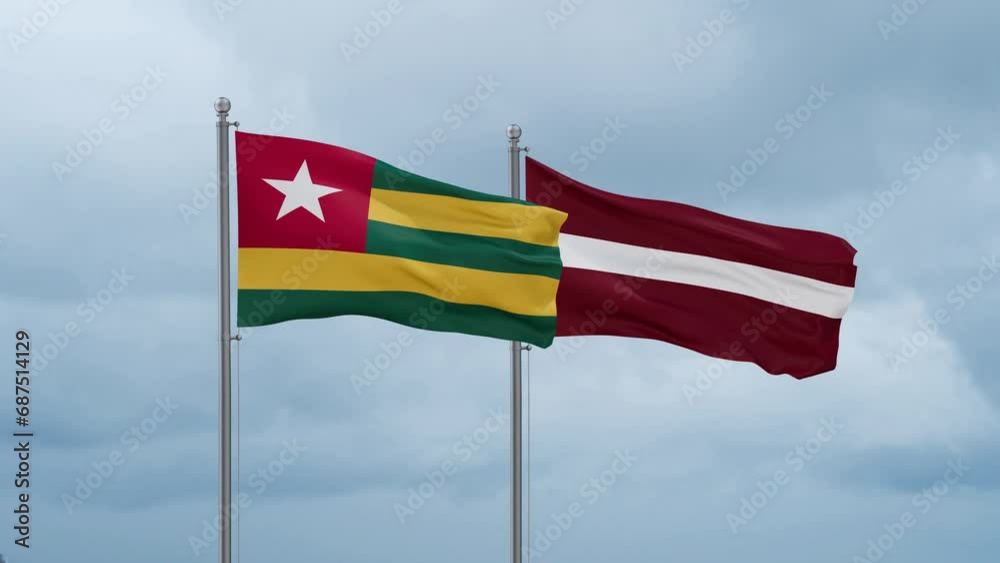 Latvia and Togo flag waving together on cloudy sky, endless seamless loop, two country cooperation concept Latvia and Togo flag waving together on cloudy sky, endless seamless loop, two country cooperation concept
