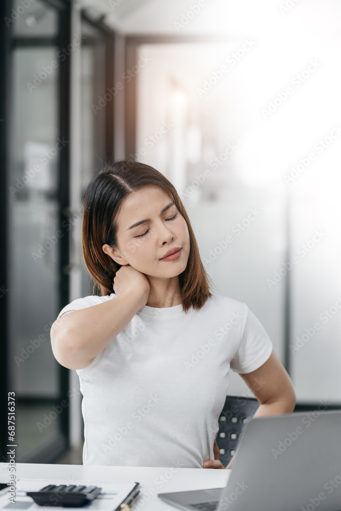 Women sitting at home office workplace gesture neck pain office syndrome concept.