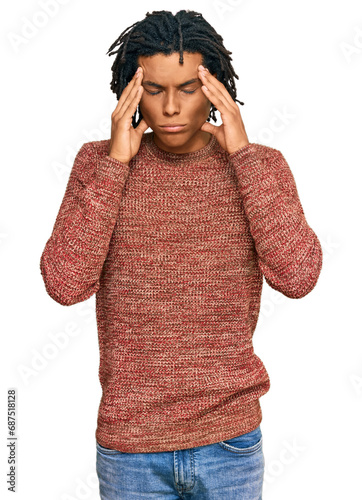 Young african american man wearing casual winter sweater suffering from headache desperate and stressed because pain and migraine. hands on head.