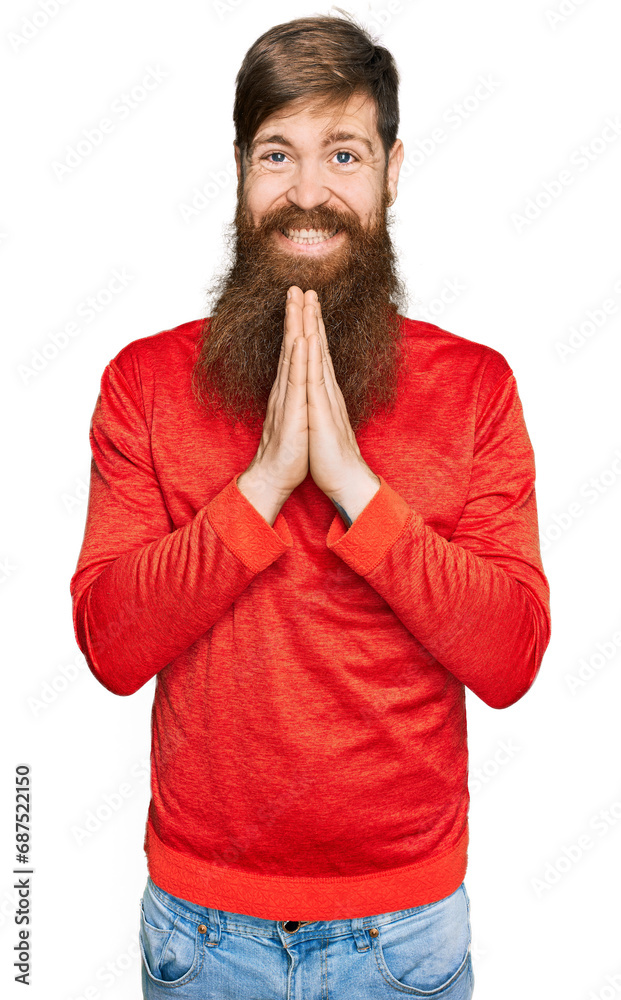 Redhead man with long beard wearing casual clothes praying with hands together asking for forgiveness smiling confident. Redhead man with long beard wearing casual clothes praying with hands together asking for forgiveness smiling confident.