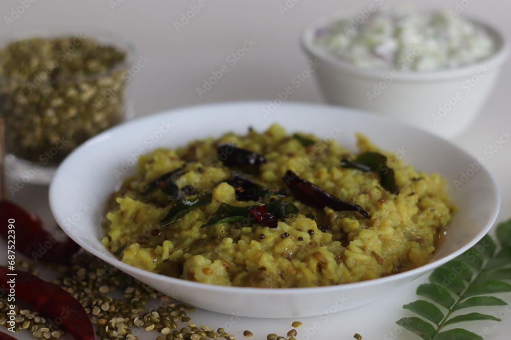Wholesome Moong Dal Kichadi paired with refreshing cucumber raita, a balanced Indian meal Wholesome Moong Dal Kichadi paired with refreshing cucumber raita, a balanced Indian meal