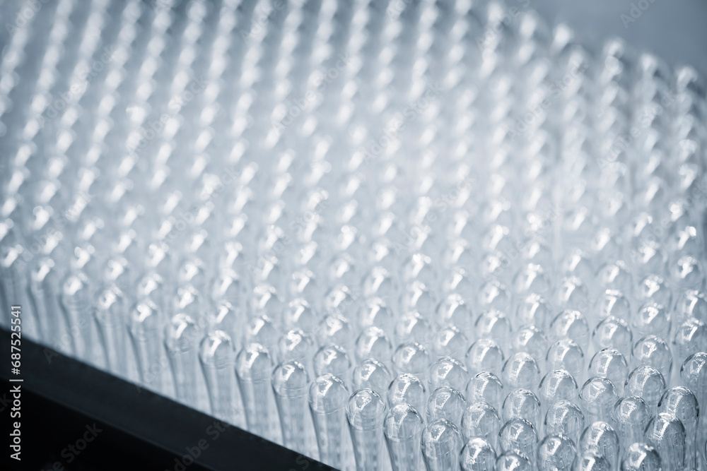 Fototapeta premium Vaccine production in a pharmaceutical factory, conveyor with the glass jars, modern pharmaceutical factory. Closeup of ampules are being filled with vaccine