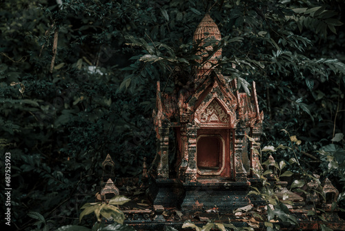 A beautiful little abandoned temple in the jungle. Green leaves. Ancient architecture of Asia. photo