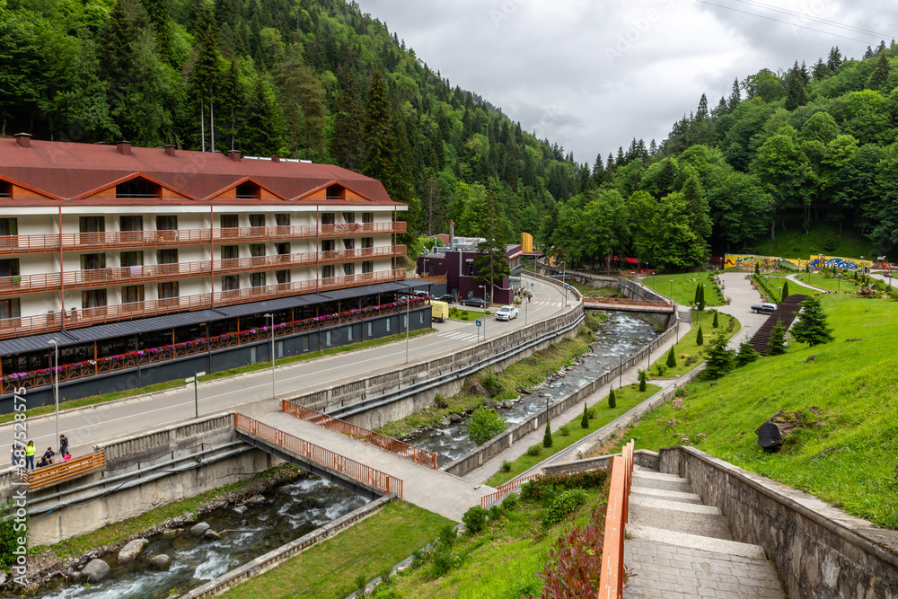 Health resort Sairme in Lesser Caucasus mounatins with natural thermal pools and mineral waters, landscape view with Bostania River and hotel on the hill, Georgia.