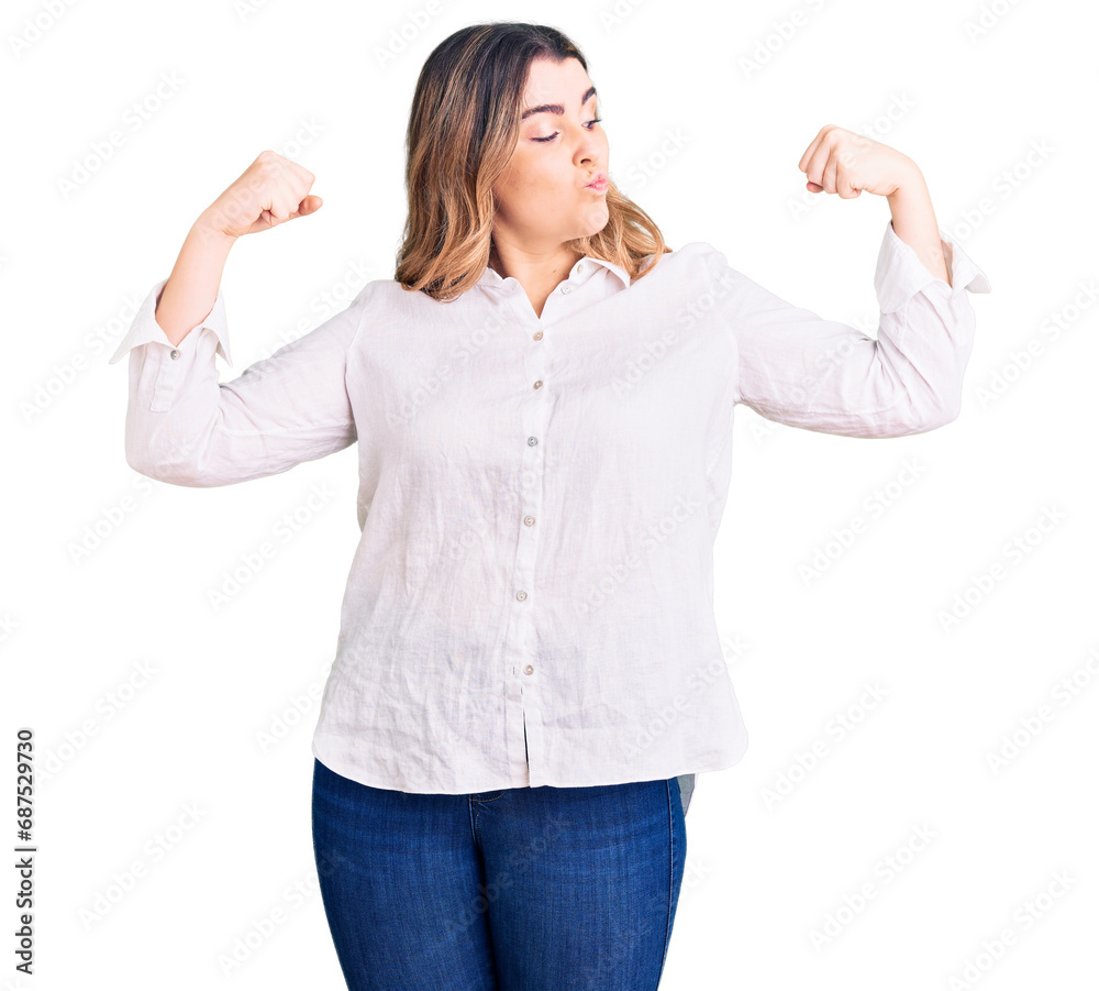 Young caucasian woman wearing casual clothes showing arms muscles smiling proud. fitness concept. Young caucasian woman wearing casual clothes showing arms muscles smiling proud. fitness concept.