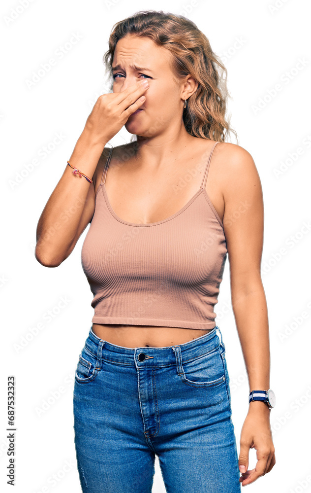 Beautiful caucasian woman wearing casual clothes smelling something stinky and disgusting, intolerable smell, holding breath with fingers on nose. bad smell Beautiful caucasian woman wearing casual clothes smelling something stinky and disgusting, intolerable smell, holding breath with fingers on nose. bad smell