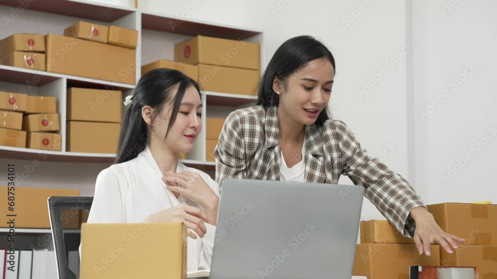 Two young Asian women are happy and excited after receiving a new order from an SME customer. Commercial inspection online marketing SME entrepreneur packaging box 4k video Two young Asian women are happy and excited after receiving a new order from an SME customer. Commercial inspection online marketing SME entrepreneur packaging box 4k video