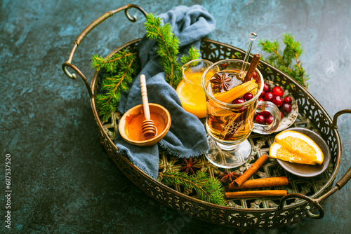 Delicious white mulled wine with orange, honey, cranberries and spices photo
