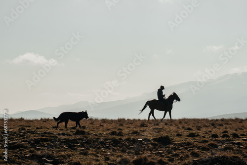 A shepherd rides a horse in the mountains © Павел Чигирь