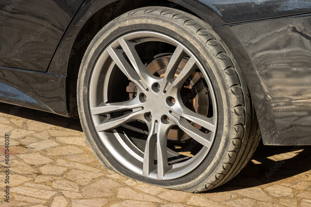 Burst flat car tire wheel. On a car