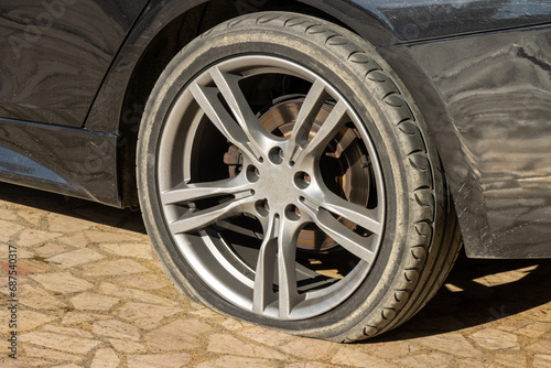Burst flat car tire wheel. On a car © Tminaz