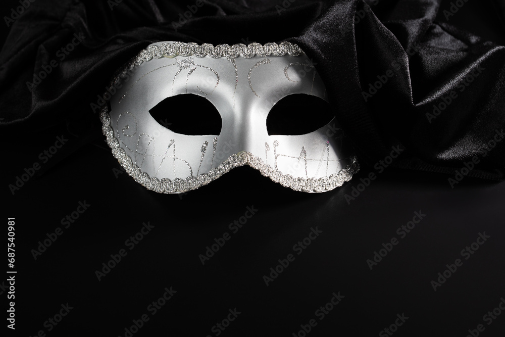 theatrical mask with fabric on a black background, opera and theater, performance on stage,copy space