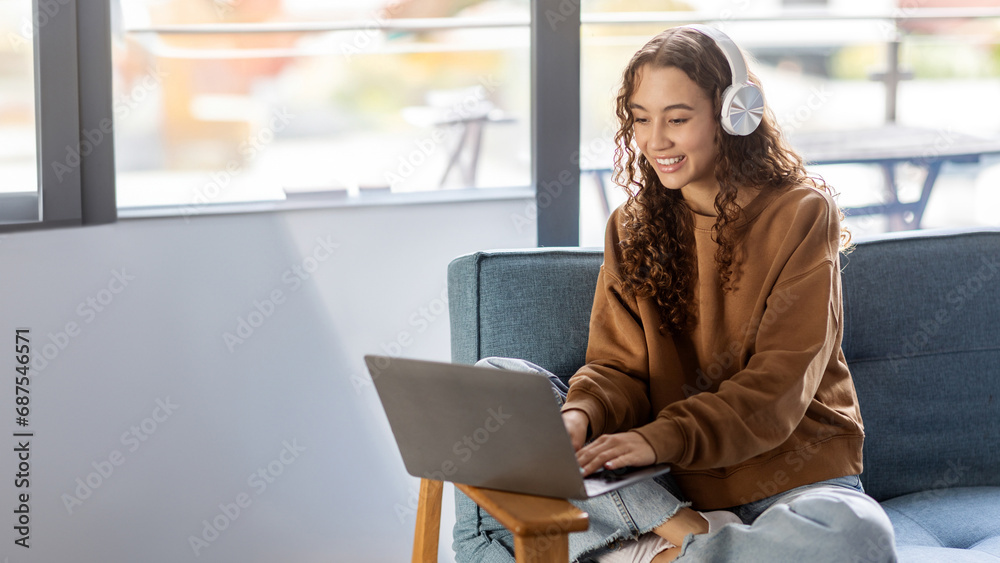 Cheerful teenage student girl using laptop computer at home Cheerful teenage student girl using laptop computer at home