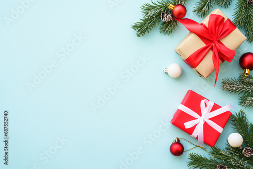 Christmas background. Christmas present box and decorations at blue. Flat lay image with copy space.