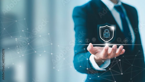 Businessman holds a shield with a lock in his hand on a global network connection. Data protection and network security insurance business and prevention of cybercrime