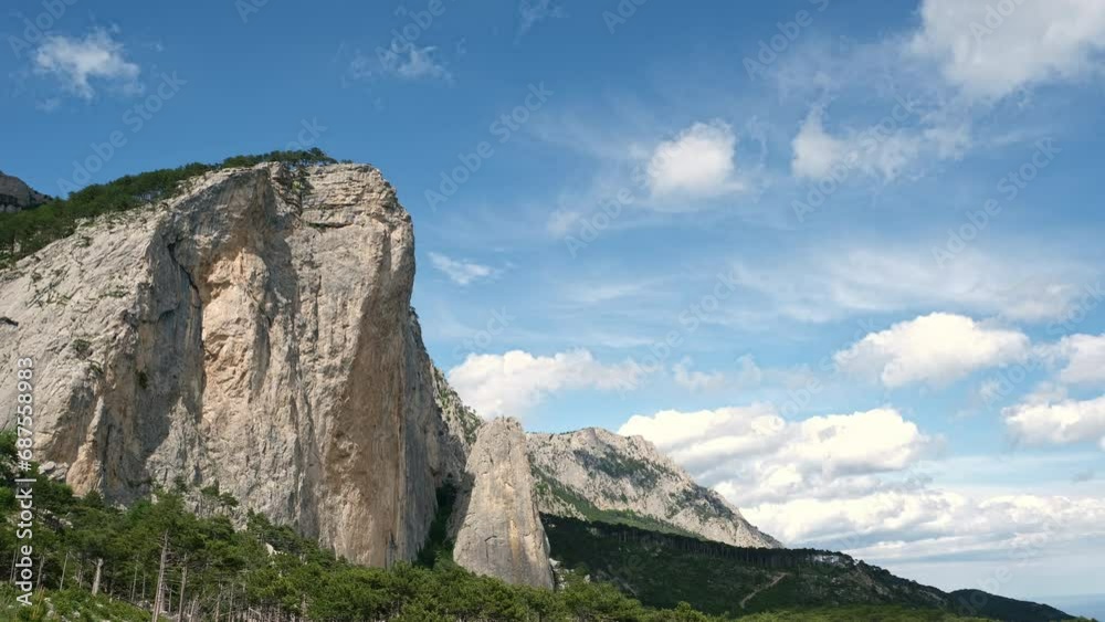 A Majestic Mountain Towering Over a Vertical Cliff Face A Majestic Mountain Towering Over a Vertical Cliff Face