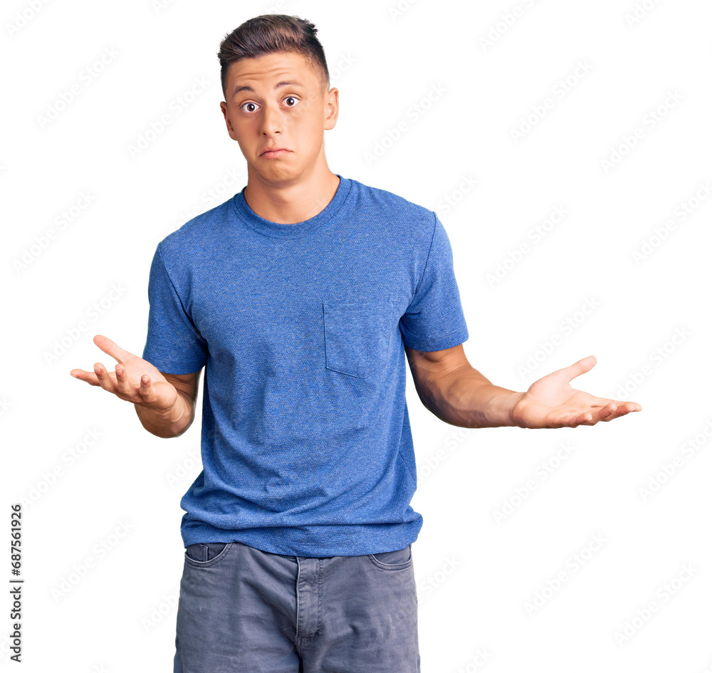 Young handsome hispanic man wearing casual clothes clueless and confused expression with arms and hands raised. doubt concept. Young handsome hispanic man wearing casual clothes clueless and confused expression with arms and hands raised. doubt concept.