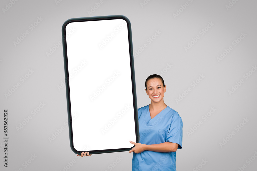 Woman nurse presenting large blank smartphone screen Woman nurse presenting large blank smartphone screen