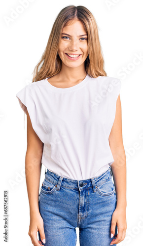 Beautiful caucasian woman with blonde hair wearing casual white tshirt with a happy and cool smile on face. lucky person.