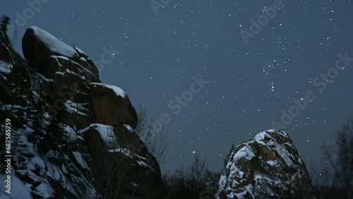The Majestic Night Sky: A Celestial Tapestry of Stars Above Twinkling Rocks photo