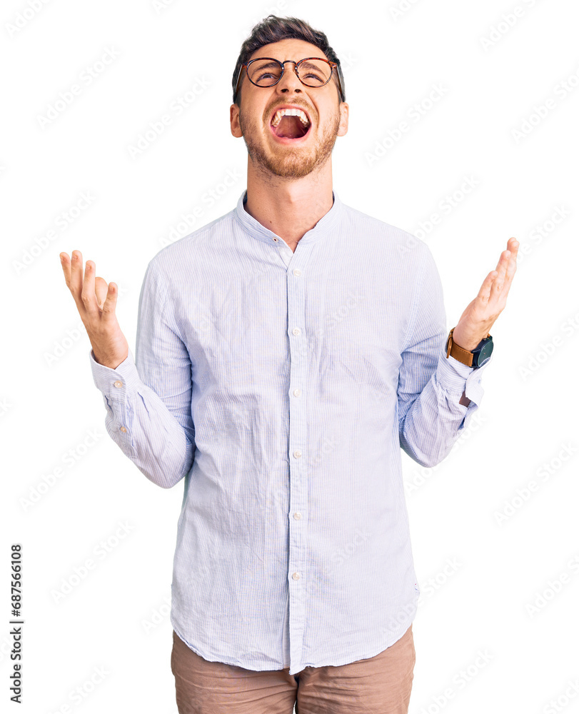 Handsome young man with bear wearing elegant business shirt and glasses crazy and mad shouting and yelling with aggressive expression and arms raised. frustration concept. Handsome young man with bear wearing elegant business shirt and glasses crazy and mad shouting and yelling with aggressive expression and arms raised. frustration concept.