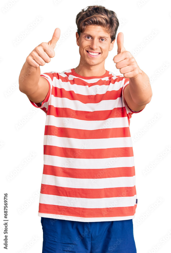 Young handsome man wearing casual clothes approving doing positive gesture with hand, thumbs up smiling and happy for success. winner gesture. Young handsome man wearing casual clothes approving doing positive gesture with hand, thumbs up smiling and happy for success. winner gesture.