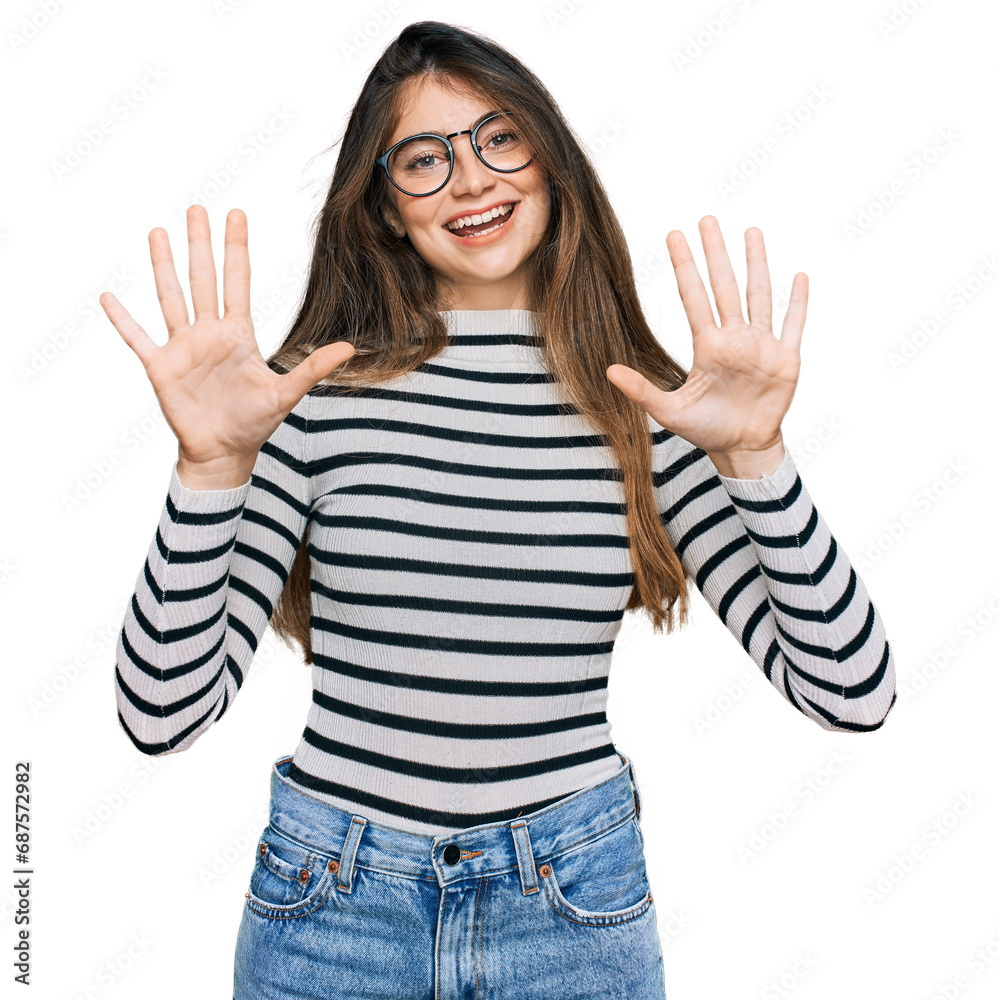 Young beautiful teen girl wearing casual clothes and glasses showing and pointing up with fingers number ten while smiling confident and happy. Young beautiful teen girl wearing casual clothes and glasses showing and pointing up with fingers number ten while smiling confident and happy.