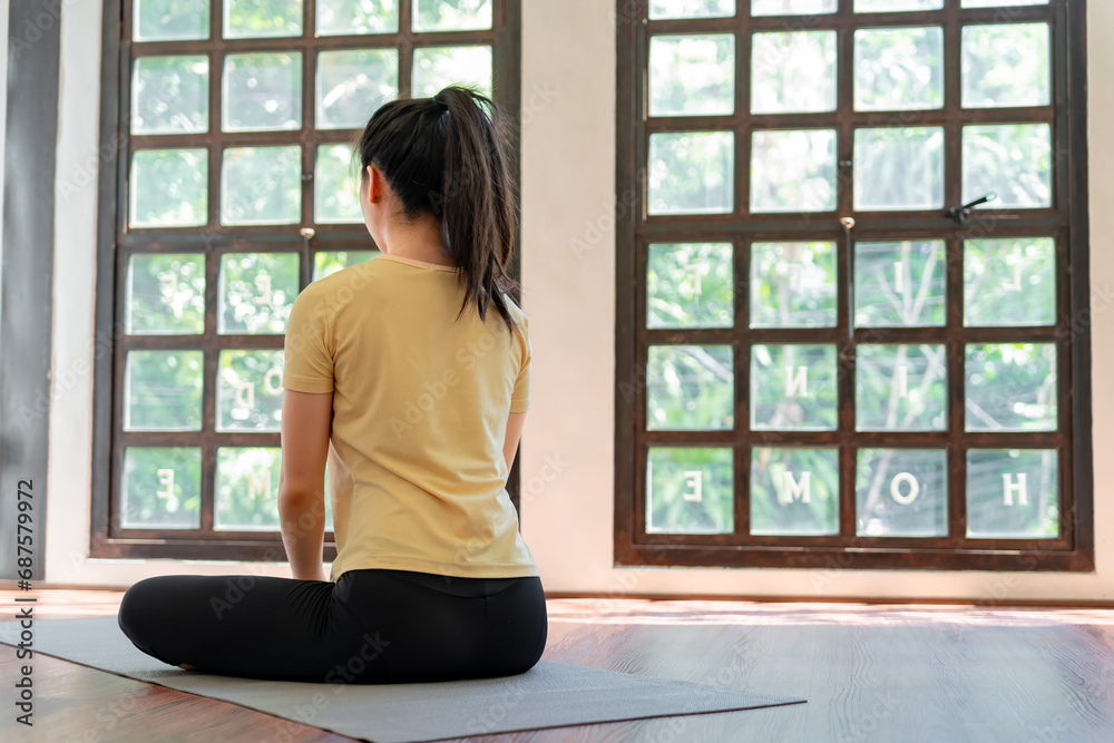 Female girl Attractive young asian woman doing stretching exercise on mat yoga Calmness and relax at gym Full body concentrated flexibility during workout Female girl Attractive young asian woman doing stretching exercise on mat yoga Calmness and relax at gym Full body concentrated flexibility during workout