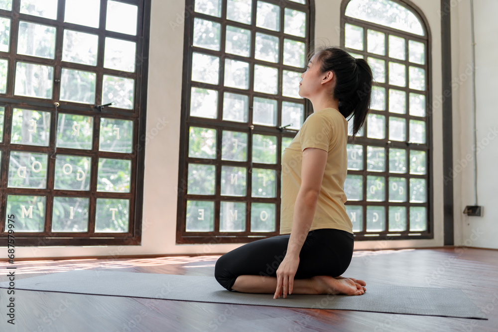 Female girl Attractive young asian woman doing stretching exercise on mat yoga Calmness and relax at gym Full body concentrated flexibility during workout Female girl Attractive young asian woman doing stretching exercise on mat yoga Calmness and relax at gym Full body concentrated flexibility during workout
