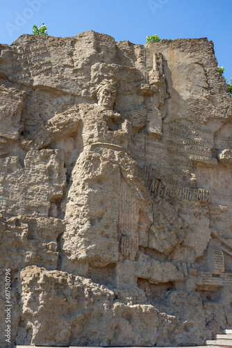 Mamaev Hill War Memorial in Volgograd city, Russia. Close-up view of decorated wall with bas-reliefs in memories of fallen soviet soldiers defending motherland. Soft focus. Russian culture theme.