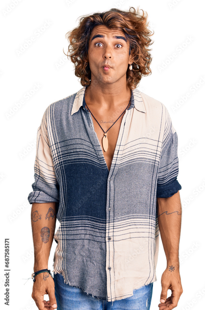 Young hispanic man wearing summer style making fish face with lips, crazy and comical gesture. funny expression. Young hispanic man wearing summer style making fish face with lips, crazy and comical gesture. funny expression.
