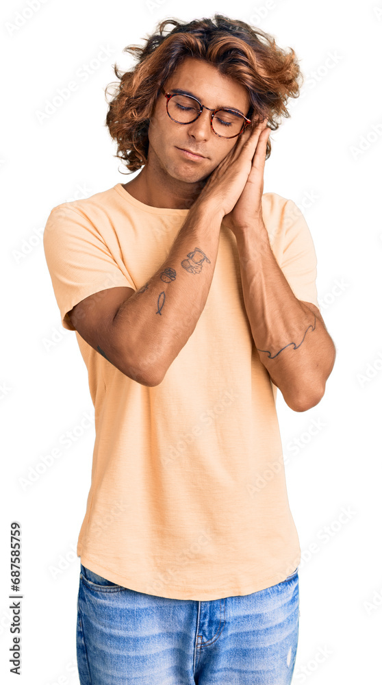 Young hispanic man wearing casual clothes and glasses sleeping tired dreaming and posing with hands together while smiling with closed eyes. Young hispanic man wearing casual clothes and glasses sleeping tired dreaming and posing with hands together while smiling with closed eyes.