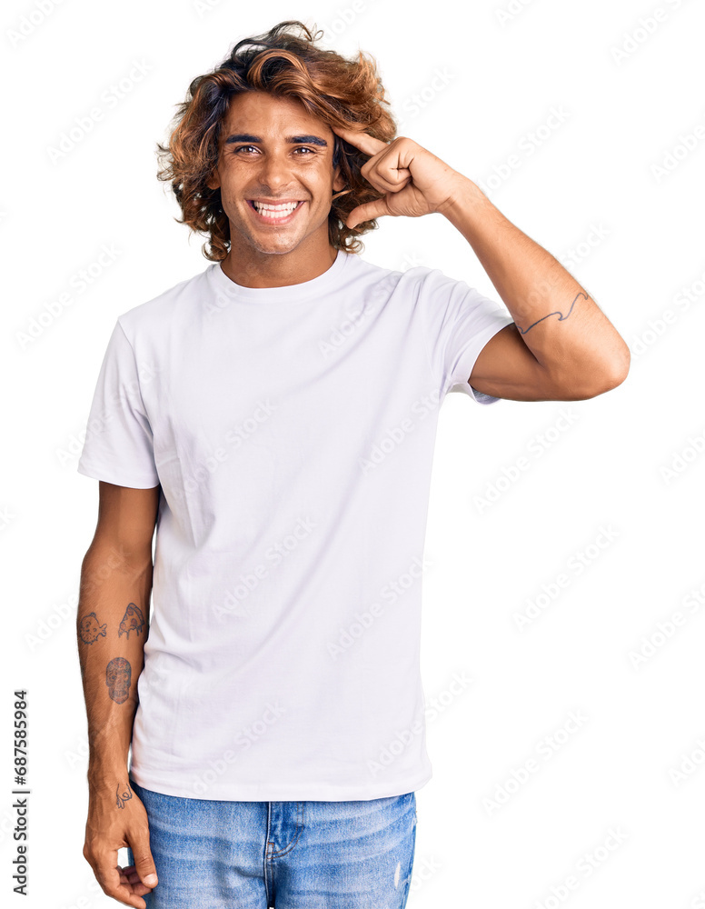Young hispanic man wearing casual white tshirt smiling pointing to head with one finger, great idea or thought, good memory Young hispanic man wearing casual white tshirt smiling pointing to head with one finger, great idea or thought, good memory