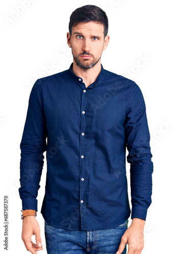 Young handsome man wearing casual shirt skeptic and nervous, frowning upset because of problem. negative person.