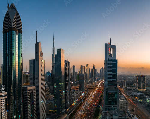 High view point of Sheikh Zayed road in rush hour, Dubai, UAE, in the blue hour at dusk with Burj Khalifa in the distance and modern skyscrapers in the foreground