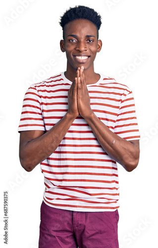 Young african american man wearing casual clothes praying with hands together asking for forgiveness smiling confident.