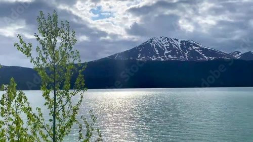 Kenai Lake (Dena'ina: Sqilan Bena) is a large, zig-zag shaped lake on the Kenai Peninsula, Alaska. The lake forms the headwaters of the Kenai River. Riding on the Alaska Railroad (ARR). photo