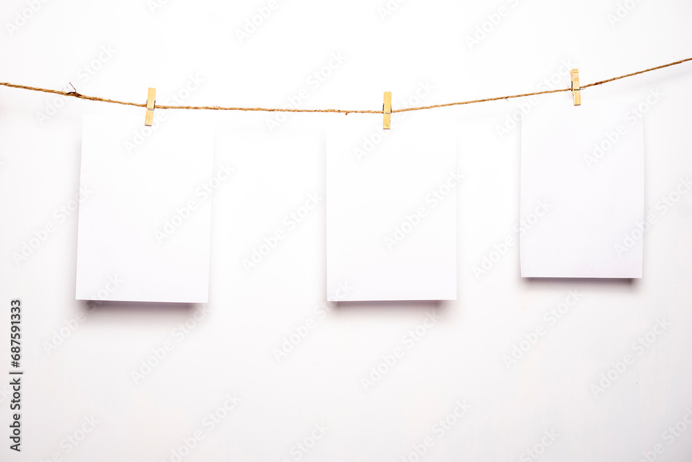 White blank pages are hanging on isolated white background. White blank pages are hanging on isolated white background.