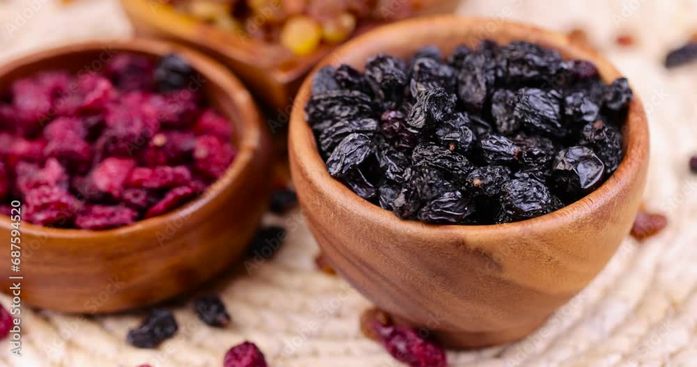 dried black raisins on the table, small dark raisins during cooking dried black raisins on the table, small dark raisins during cooking