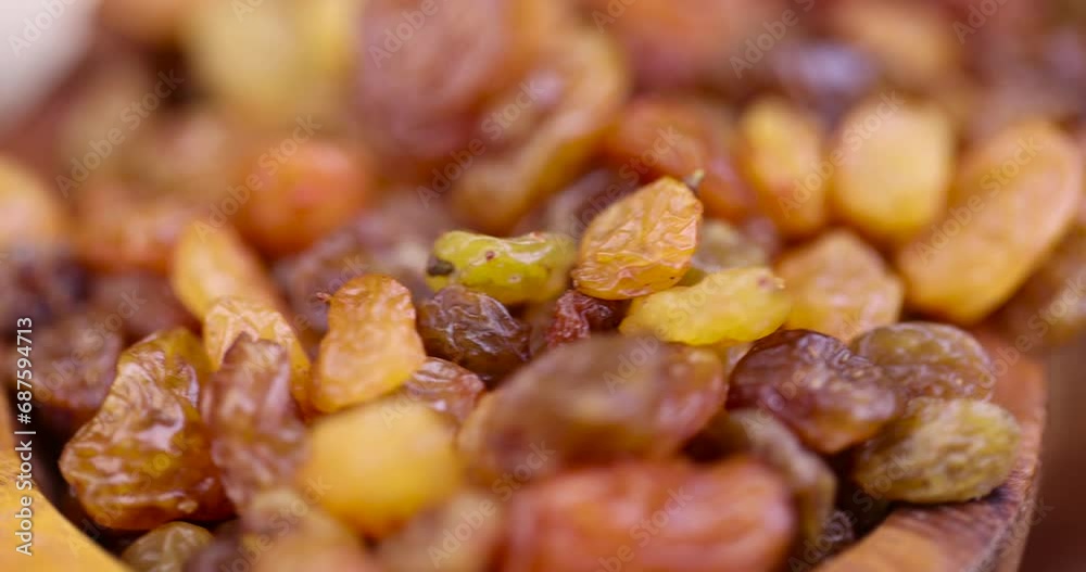 dried golden-colored raisins on the table, small yellow raisins during cooking dried golden-colored raisins on the table, small yellow raisins during cooking
