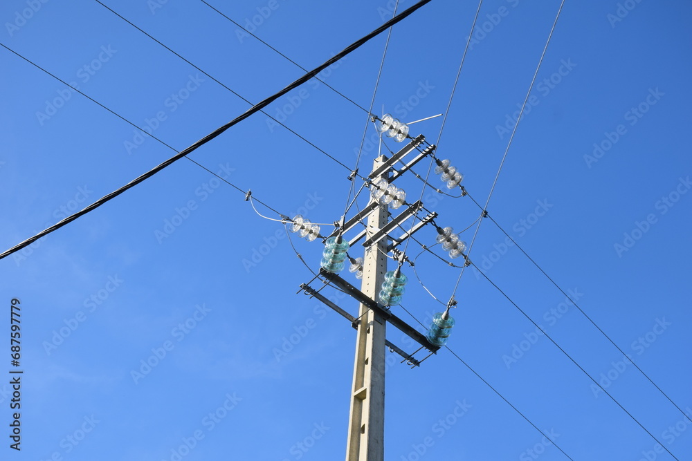 Utility pole with electricity cables seen from the ground, clear sky above Utility pole with electricity cables seen from the ground, clear sky above